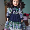 Identifying Porcelain Dolls - dark haired doll wearing a plaid and dark blue dress