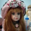 Identifying a Greek Porcelain Doll - red haired doll with a pink plaid and floral outfit