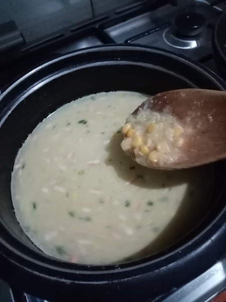 adding corn to soup