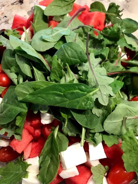 spring mix added to salad