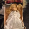 Value of a Porcelain Doll - unidentified doll in a box, wearing a white lace trimmed dress