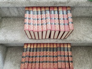 Value of Universal Standard Encyclopedias - volumes on grey carpet stairs