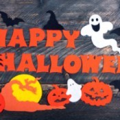 Happy Halloween spelled out with cut paper.