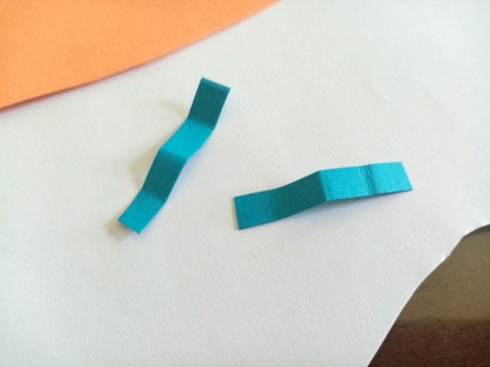 Making a Paper Butterfly Puppet - cut two small paper strips using a different color, then fold into zigzags