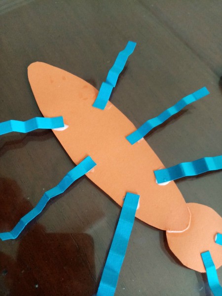 Making a Paper Butterfly Puppet - attach 3 to each side as the legs