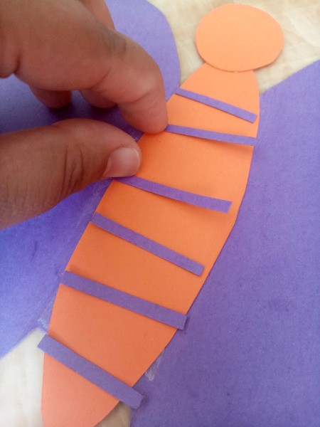 Making a Paper Butterfly Puppet - cut out thin strips of paper and arrange on the body