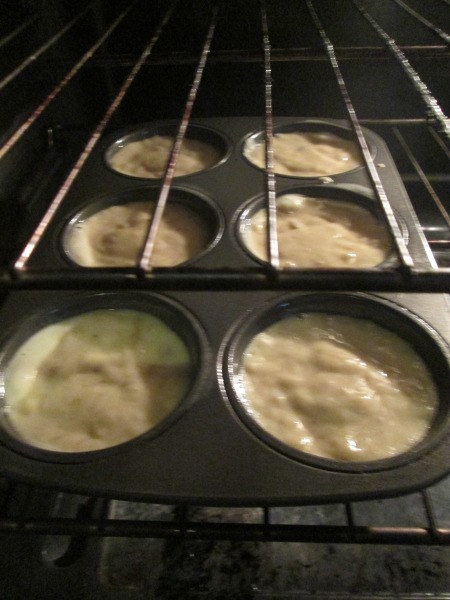 filled muffin tin in oven