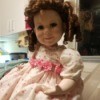 Identifying a Porcelain Doll - doll with ringlets wearing a flowered dress
