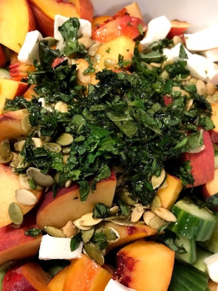 adding herbs to Peach and Cucumber Salad