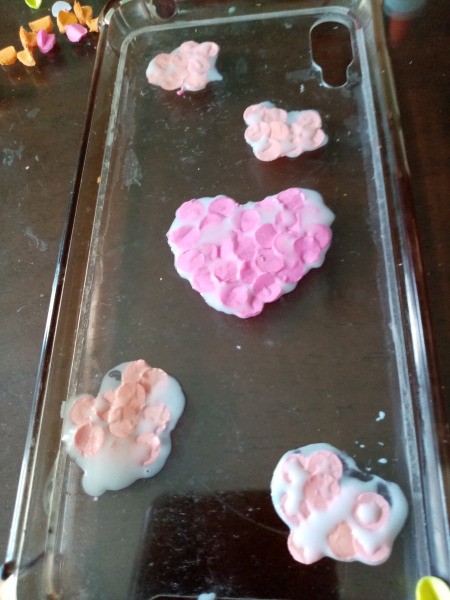 Fixing Jelly Phone Case with Sticky Notes - place paper punches on the glue