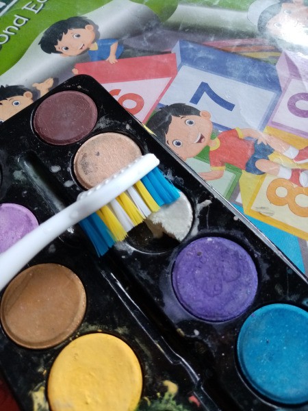 Halloween Toothbrush Spray Painting - dipping toothbrush in watercolor paint