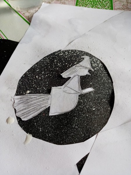 Halloween Toothbrush Spray Painting - white paint spattered on black paper to define the moon and witch