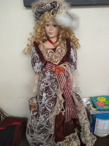 Value of a Knightsbridge Porcelain Doll - doll wearing a long maroon dress with lace in white and ecru