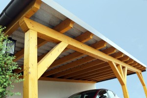 A carport with wood supports and a metal roof.