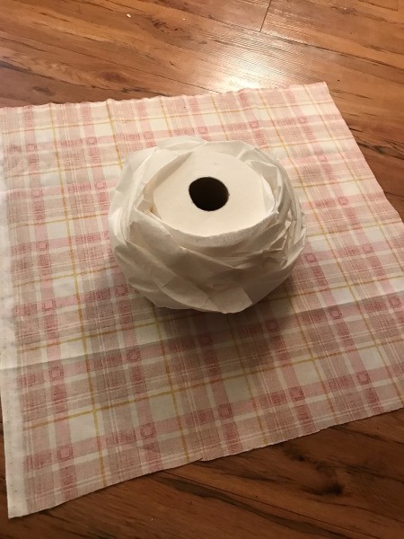 Crafty Toilet Paper Roll Pumpkins  - roll of rewrapped TP in center of the fabric on the wrong side