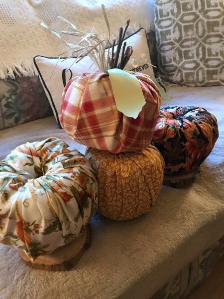 Crafty Toilet Paper Roll Pumpkins - one finished pumpkin on a row of three unfinished ones