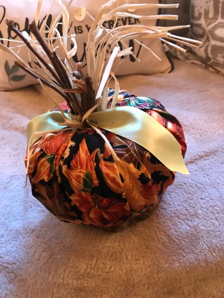 Crafty Toilet Paper Roll Pumpkins  - pumpkin made with a square of fabric with fall gourd pattern
