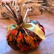 Crafty Toilet Paper Roll Pumpkins  - pumpkin made with a square of fabric with fall gourd pattern