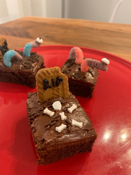 Spooky Halloween Worm Brownies - grave brownie on plate with worm brownies