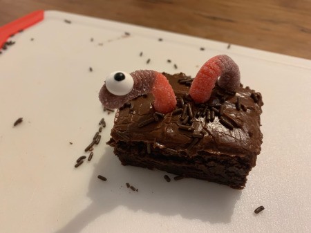 Spooky Halloween Worm Brownies - insert toothpicks to create the look of the worm going in and out of the brownie - use icing to attach one candy eye to free end of the gummy