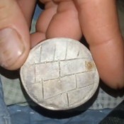 Carved Rock Identification - round stone with incising on the top surface