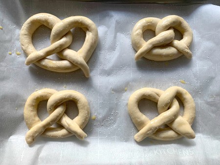 Pretzel Pumpkins - salted pretzels on parchment paper
