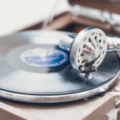 An antique phonograph playing a small record.