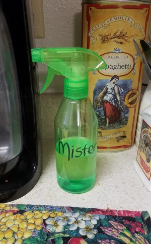 A spray bottle containing oil for cooking.