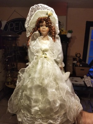 Value of a Knightsbridge Collection Porcelain Doll - doll wearing a long white dress covered in lace