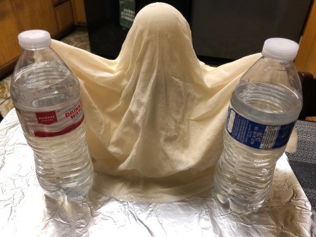 Floating Fabric Ghost - prop up the arms so that they don't fall, water bottles work