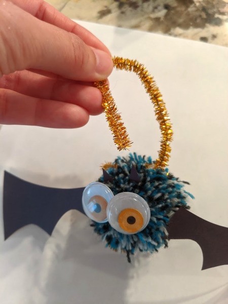 Pom Pom Bat Decoration  - bring remaining length up and connect to the part wrapped around the pom