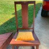 Value of an Old Rocking Chair - armless rocking chair with metal decoration on back and gold upholstered seat