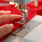 A sewing machine in use, focused on the needle.
