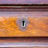 An old desk drawer with a lock.