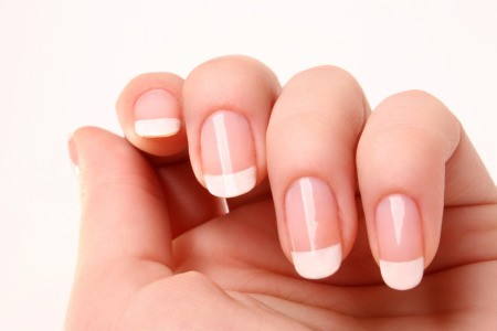 Nails with a beautiful French manicure.