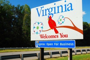 A "Virginia Welcomes You" sign on the side of a roadway.