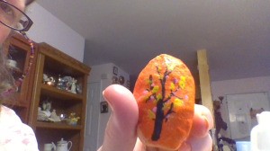 Creating Painted Rocks  - orange rock with a dark leafless tree