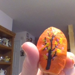 Creating Painted Rocks  - orange rock with a dark leafless tree