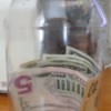 Money in a recycled plastic mayo jar.