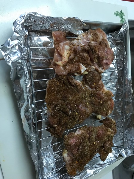 chicken thigh meat on rack to broil