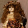 Identifying Porcelain Dolls - doll wearing a fall print dress with matching hat