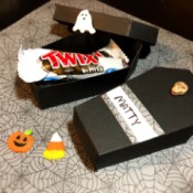 Paper Coffin Treat Boxes - open coffin with candy and other Halloween decorations