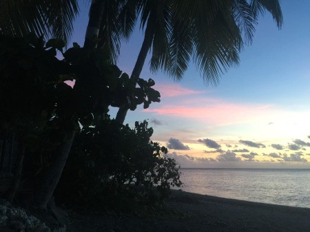 A tropical sunset on a beach in Tahiti.