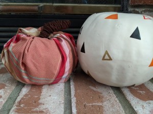 Fabric Covered Foam Pumpkin - finished pumpkin sitting next to a white pumpkin with painted triangle pattern