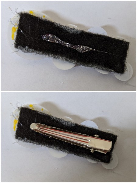 Gluing the hair clip to the back of a felt strip.
