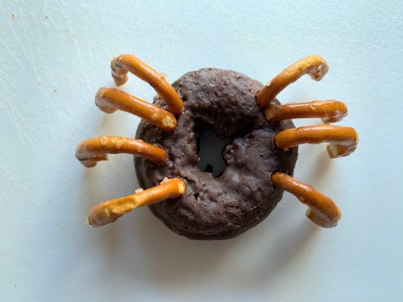 Halloween Spider Donuts - stick pretzel pieces into the donut, 4 per side