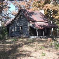 An old house surrounded by trees.