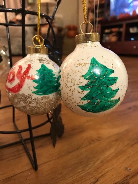 Decorated Clear and White Ornaments  - white ornaments with trees and glitter hanging to dry