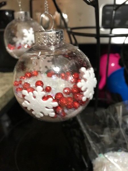 Decorated Clear and White Ornaments  - white foam snowflakes on clear ornament filled with red beads and snow