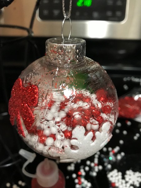 Decorated Clear and White Ornaments - red and white bead filled ornament with a snowflake sticker and a red bow